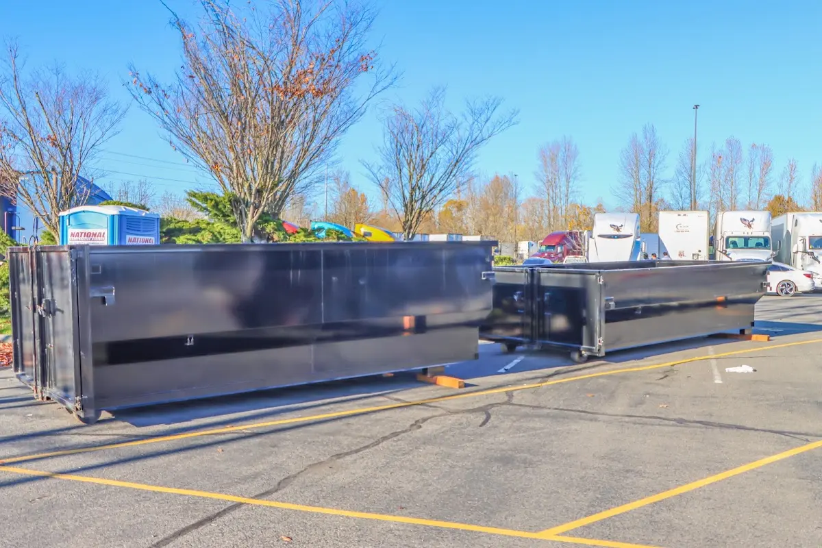 Professional dumpster rental service with roll-off container on residential driveway in Tyngsborough